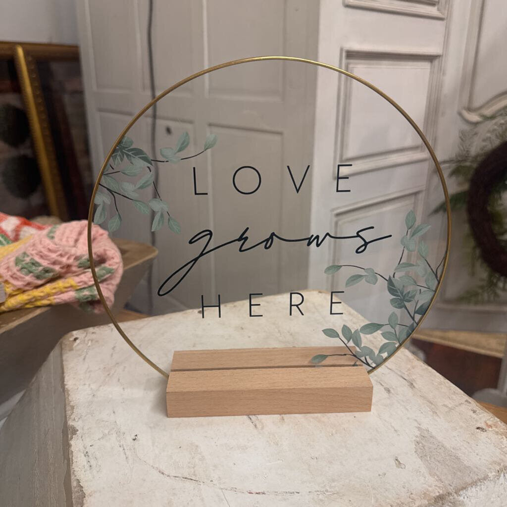LOVE GROWS HERE SIGN