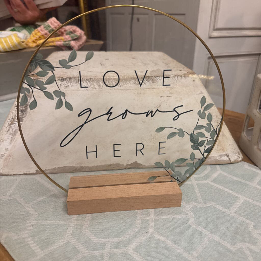 LOVE GROWS HERE SIGN