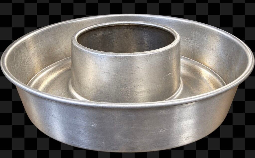 A silver metal double-ring bundt cake pan with a textured brushed finish, shown against a black and white checkered background.
