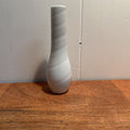 A small ceramic white bud vase.