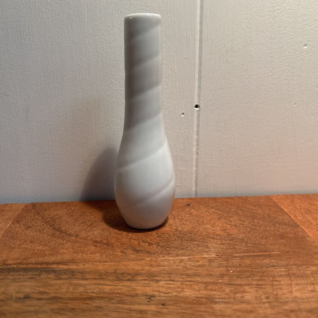 A small ceramic white bud vase.